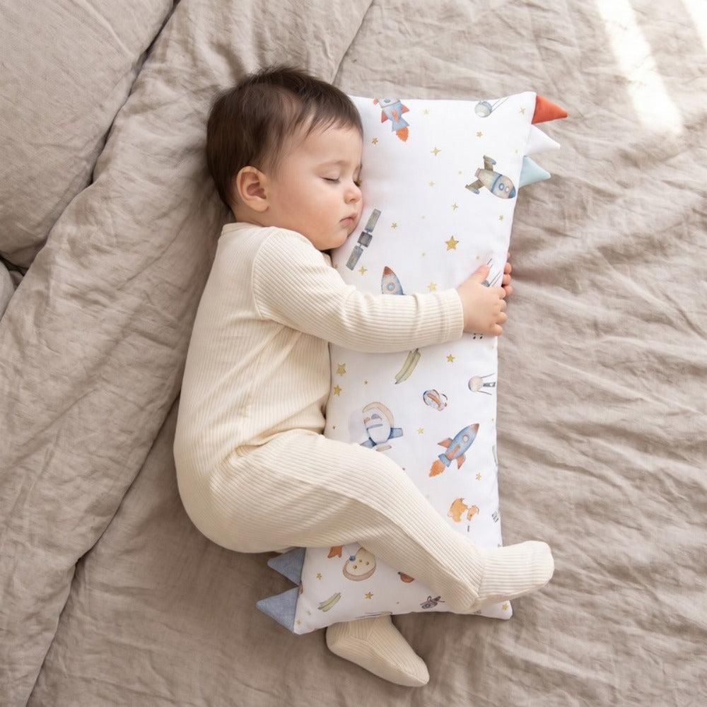 Little Manta Willow Baby Pillow on a bed